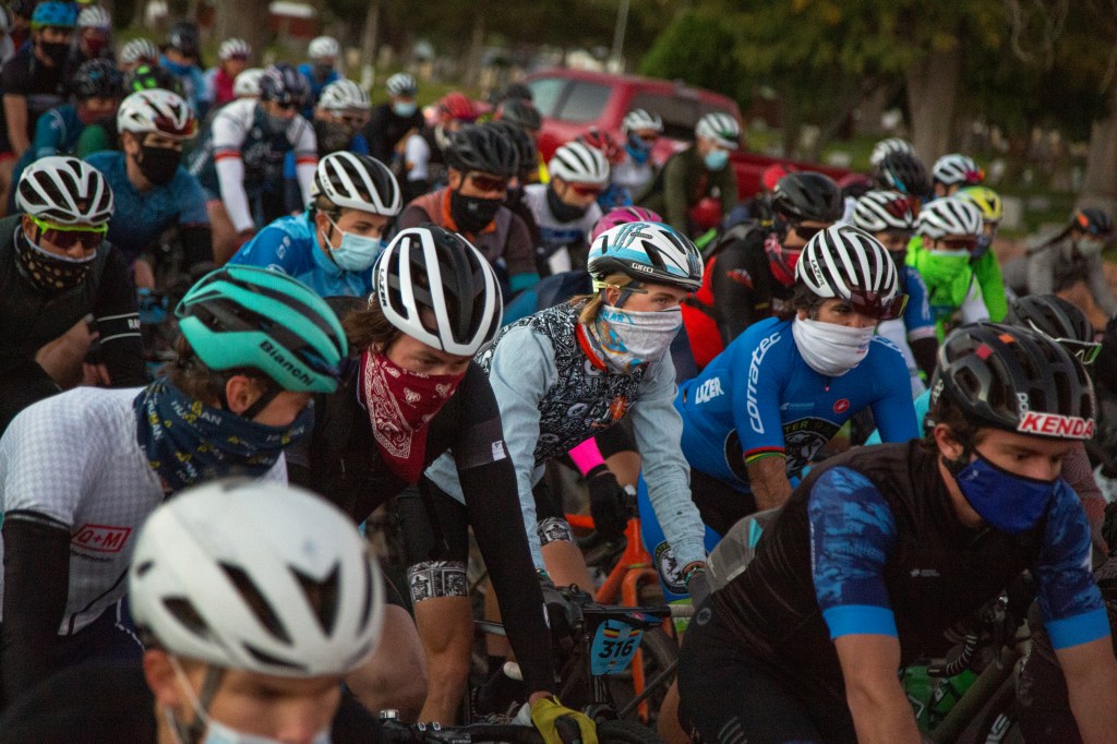 A group of people riding on the back of a large crowd of people

Description automatically generated